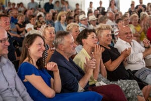 Ludzie klaszczący na publicznym wydarzeniu.