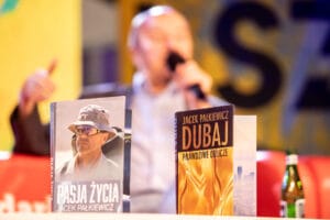 Książki na stole, tło niewyraźne.